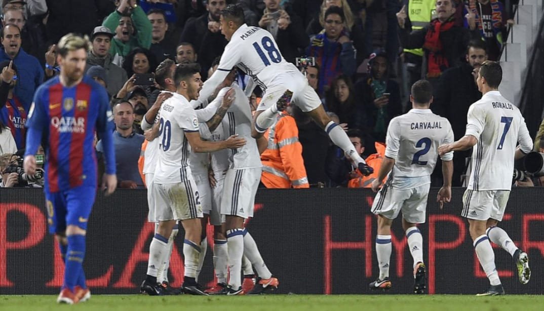 Who Has Truly Beaten Barcelona the Most? 2 Truly beaten Barcelona: Real Madrid players celebrating a goal at Camp Nou with Barcelona fans in the background.